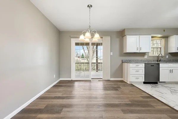a view of a kitchen with granite countertop a stove top oven