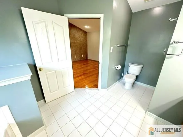 a bedroom with a bed and a rug