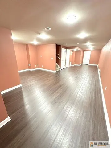 a view of a room with wooden floors and stairs