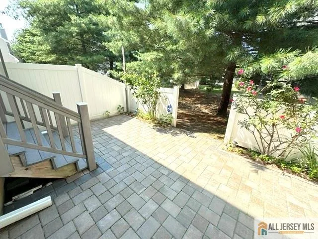 a view of a yard with wooden fence