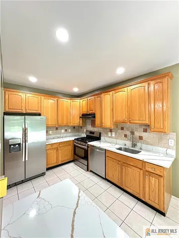 a large kitchen with a large window and counter top