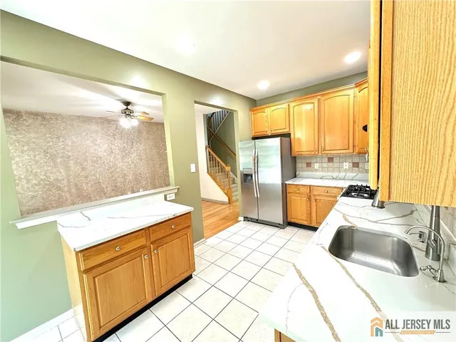 a kitchen that has a sink and a stove in it