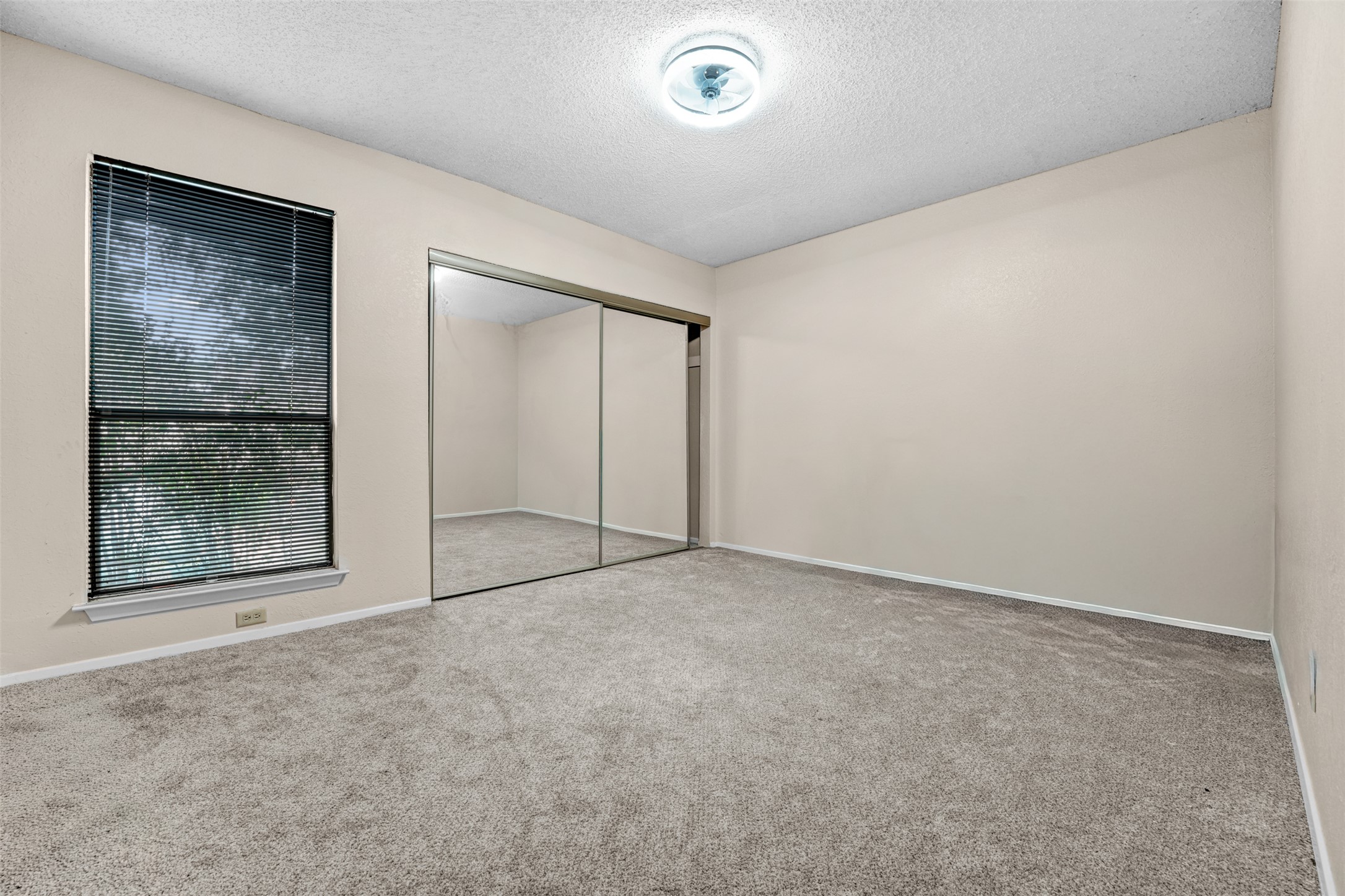 3801 Menchaca Road, Unit 24 Austin, TX 78704 - Photo 13 of 25 an empty room with sliding door and mirror