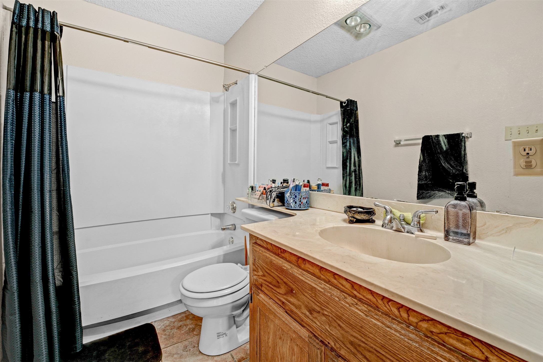 3801 Menchaca Road, Unit 24 Austin, TX 78704 - Photo 14 of 25 a bathroom with a sink a toilet and shower