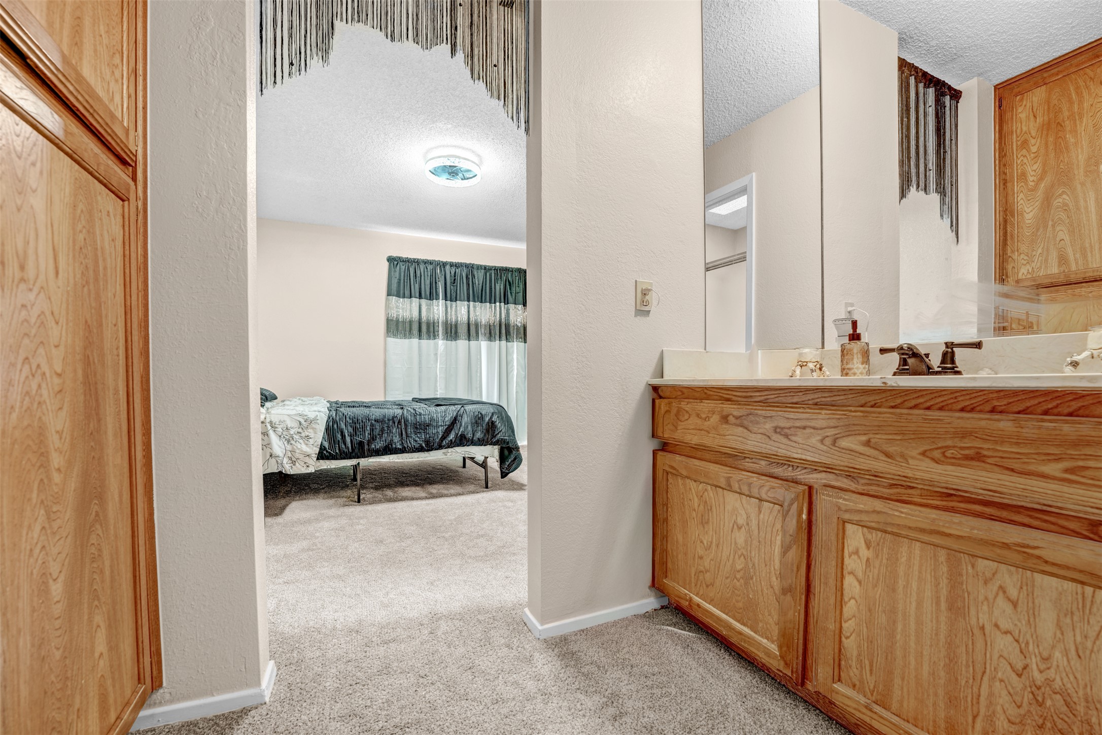 3801 Menchaca Road, Unit 24 Austin, TX 78704 - Photo 19 of 25 a en suite bathroom with a sink and a mirror