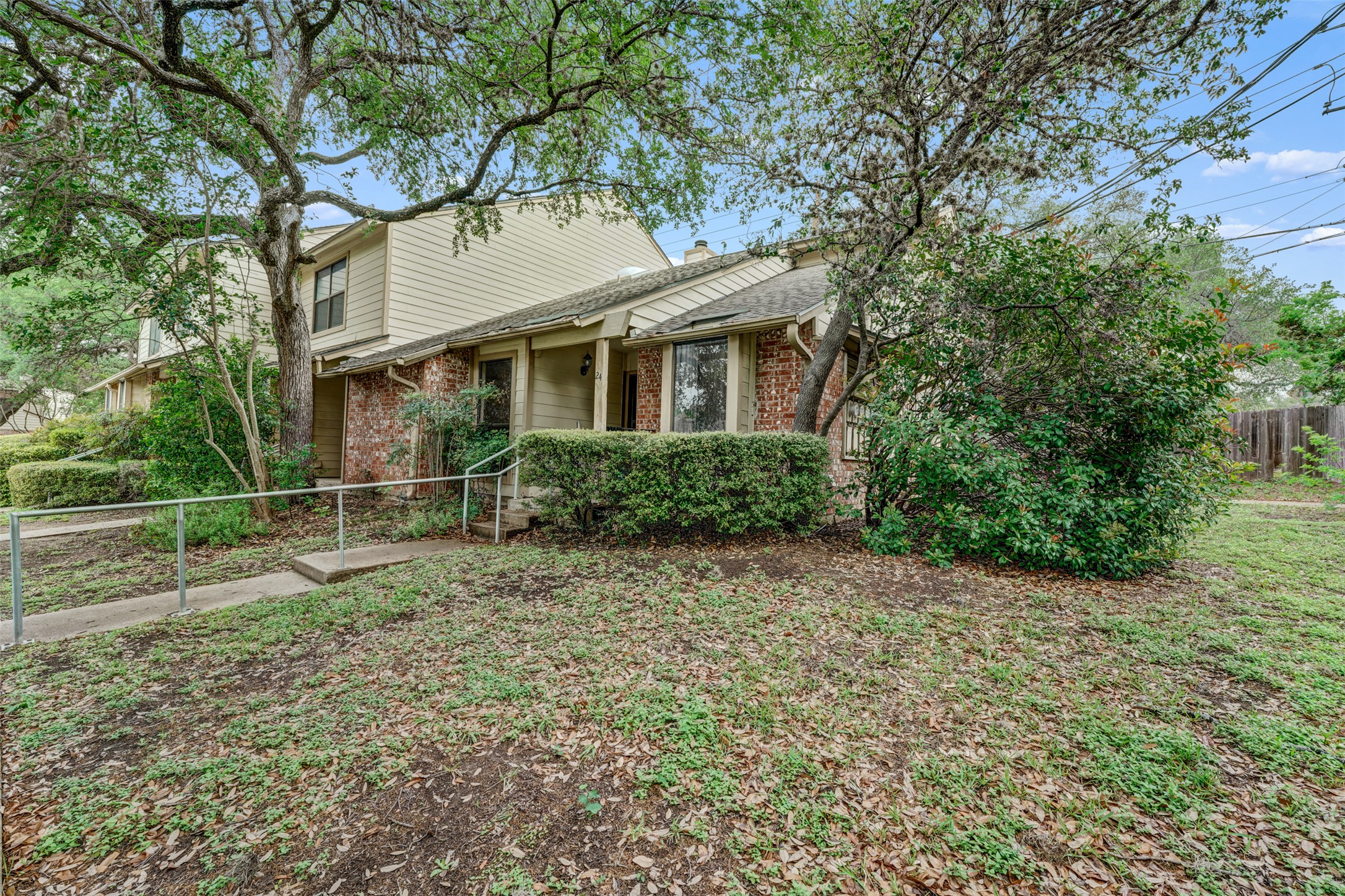 3801 Menchaca Road, Unit 24 Austin, TX 78704 - Photo 2 of 25 a backyard of a house with plants and large trees