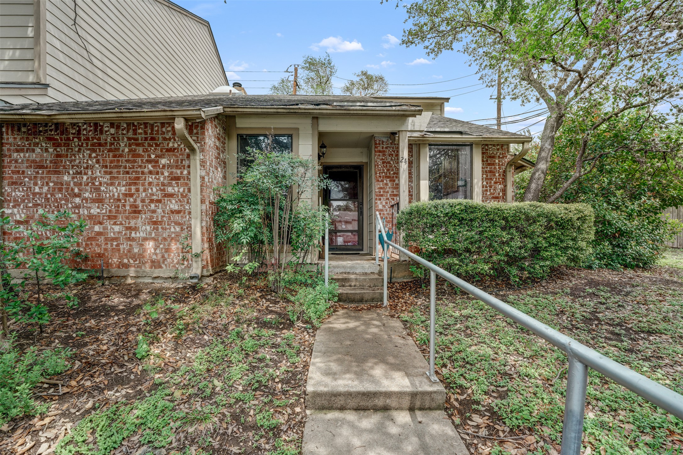 3801 Menchaca Road, Unit 24 Austin, TX 78704 - Photo 3 of 25 a front view of a house with plants
