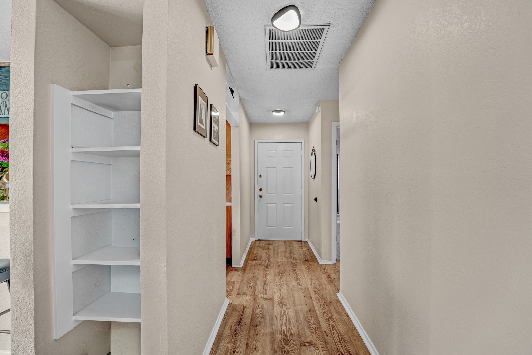 3801 Menchaca Road, Unit 24 Austin, TX 78704 - Photo 4 of 25 a view of a hallway with wooden floor and entryway