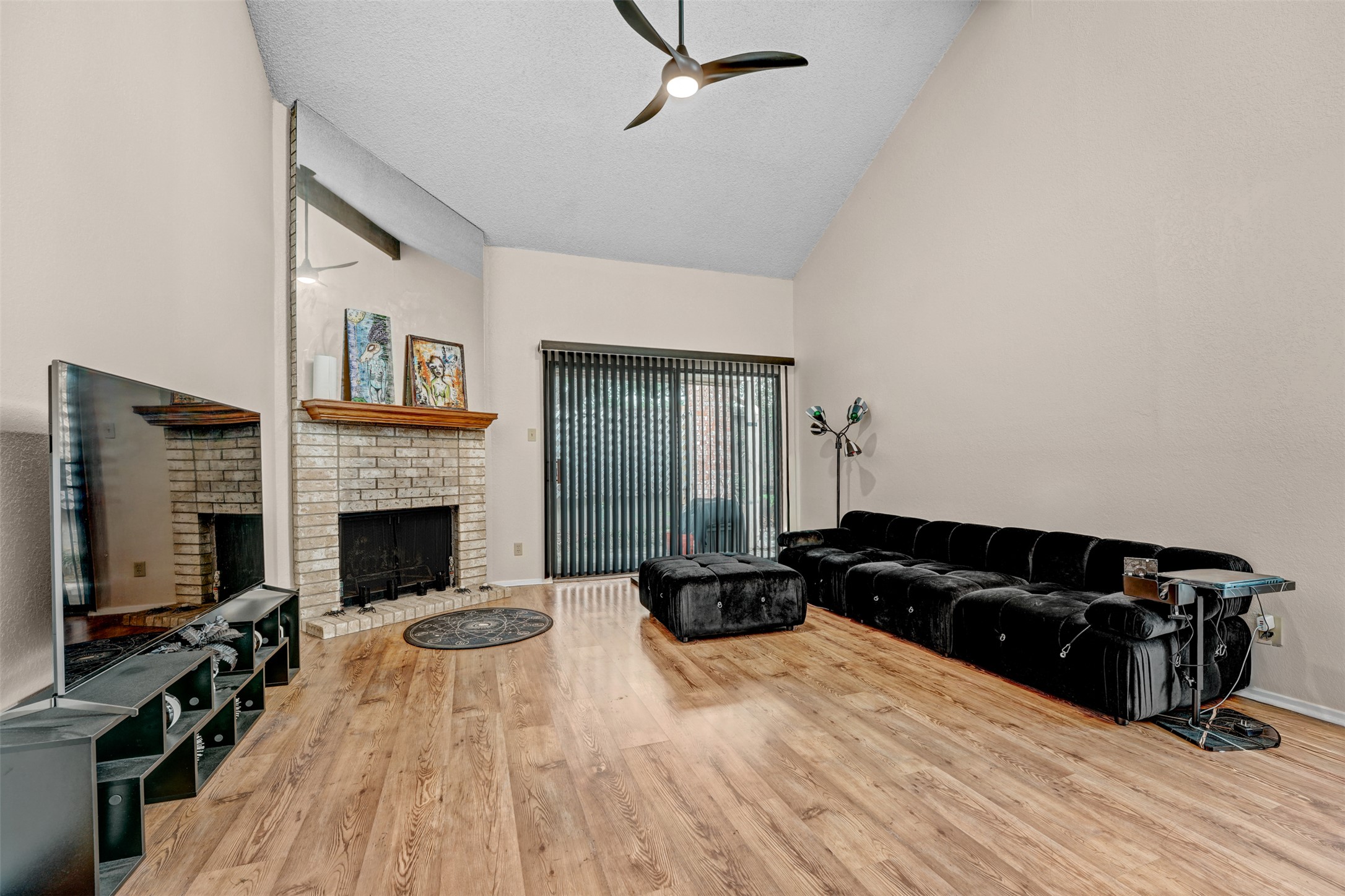 3801 Menchaca Road, Unit 24 Austin, TX 78704 - Photo 7 of 25 a living room with furniture a flat screen tv and a fireplace