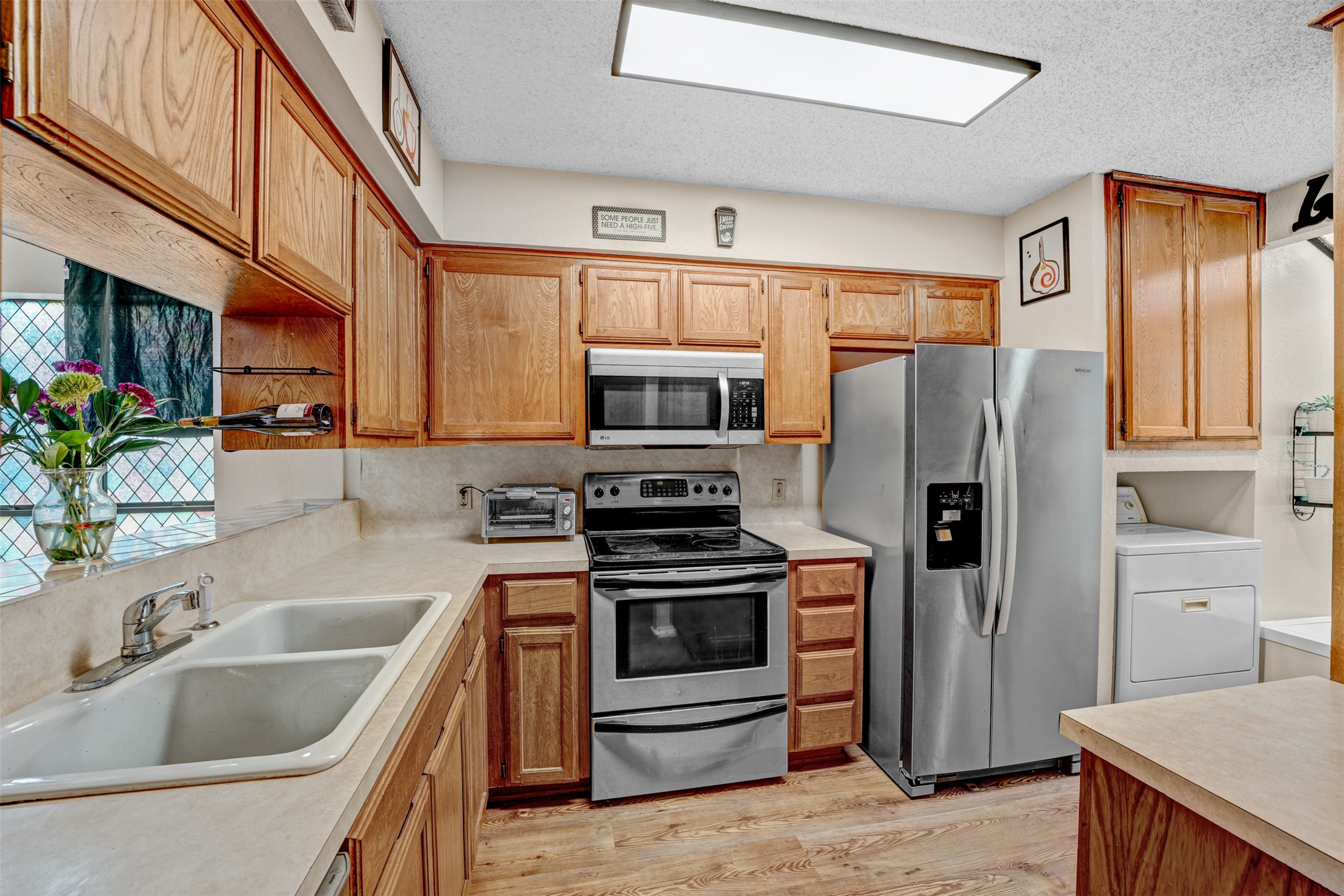 3801 Menchaca Road, Unit 24 Austin, TX 78704 - Photo 9 of 25 a kitchen with granite countertop a refrigerator and a stove top oven