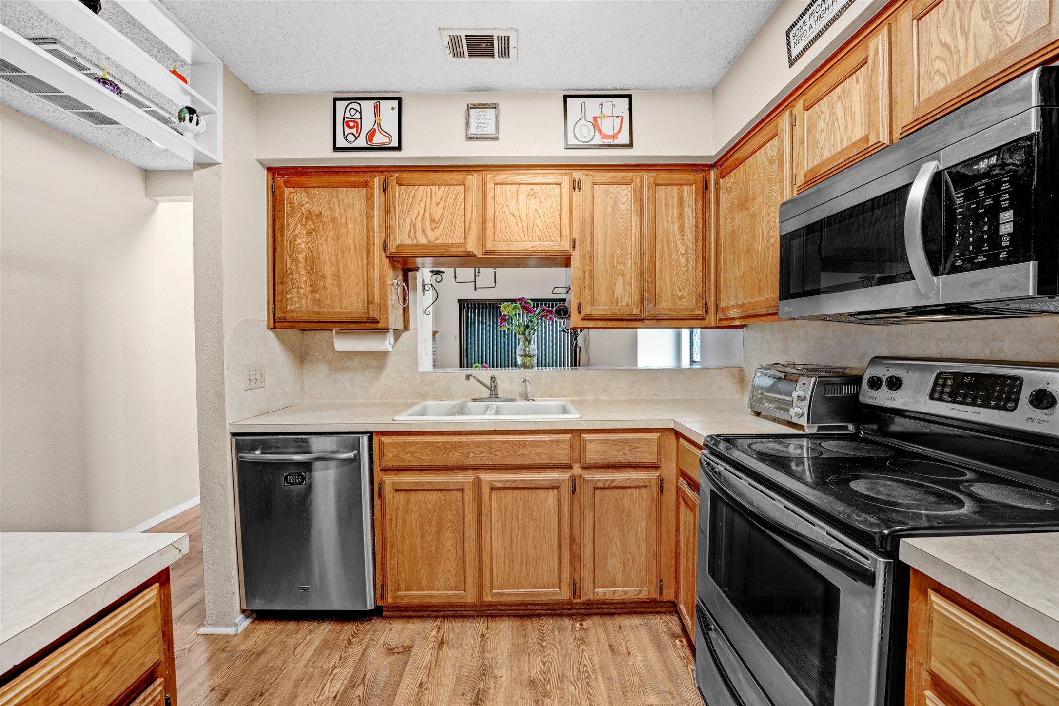 3801 Menchaca Road, Unit 24 Austin, TX 78704 - Photo 10 of 25 a kitchen with stainless steel appliances a stove sink microwave and cabinets