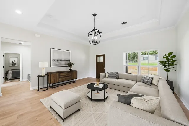 a living room with furniture a rug and a chandelier