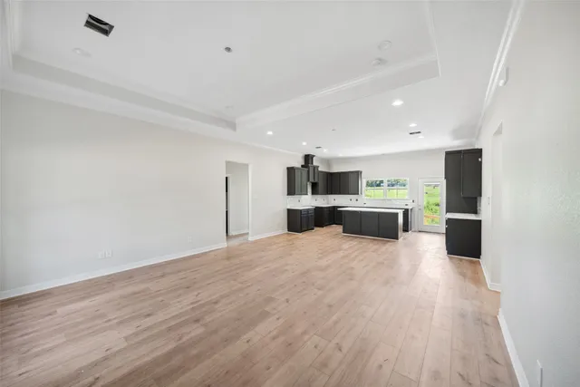 a large kitchen with a lot of counter space and stainless steel appliances
