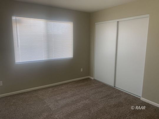 227 South Desert Candles Street Ridgecrest, CA 93555 - Photo 20 of 26 an empty room with a window