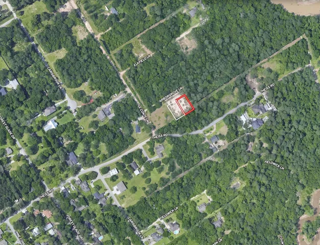 a backyard of a house with lots of green space and two chairs