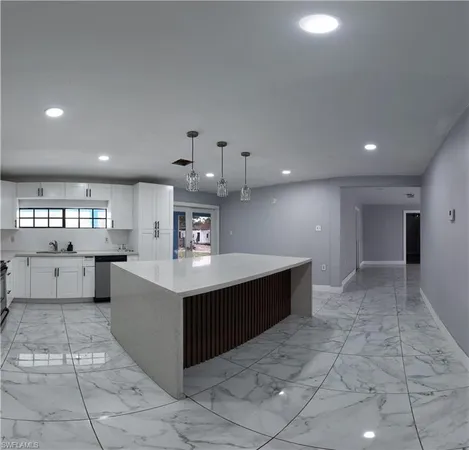 a kitchen with stainless steel appliances a sink dishwasher stove top oven and cabinets