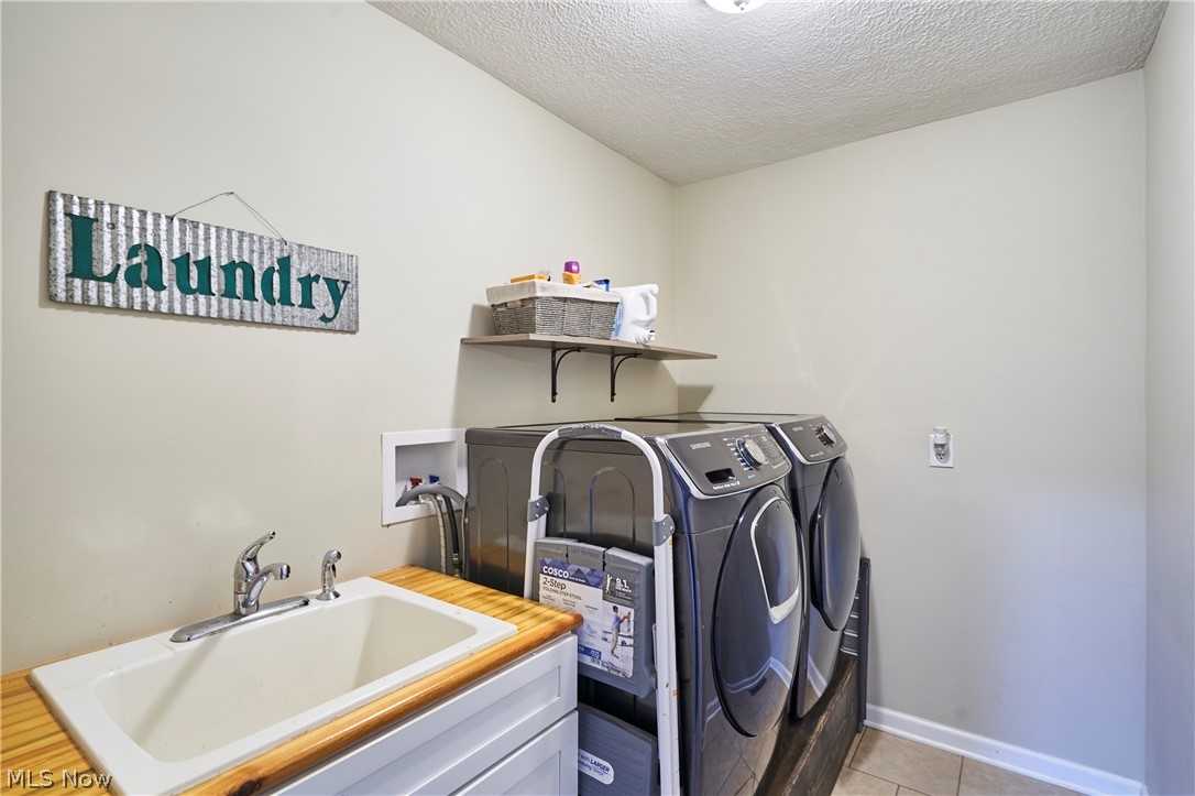 6586 Red Brush Road Ravenna, OH 44266 - Photo 15 of 27 First floor laundry with cabinet and sink
