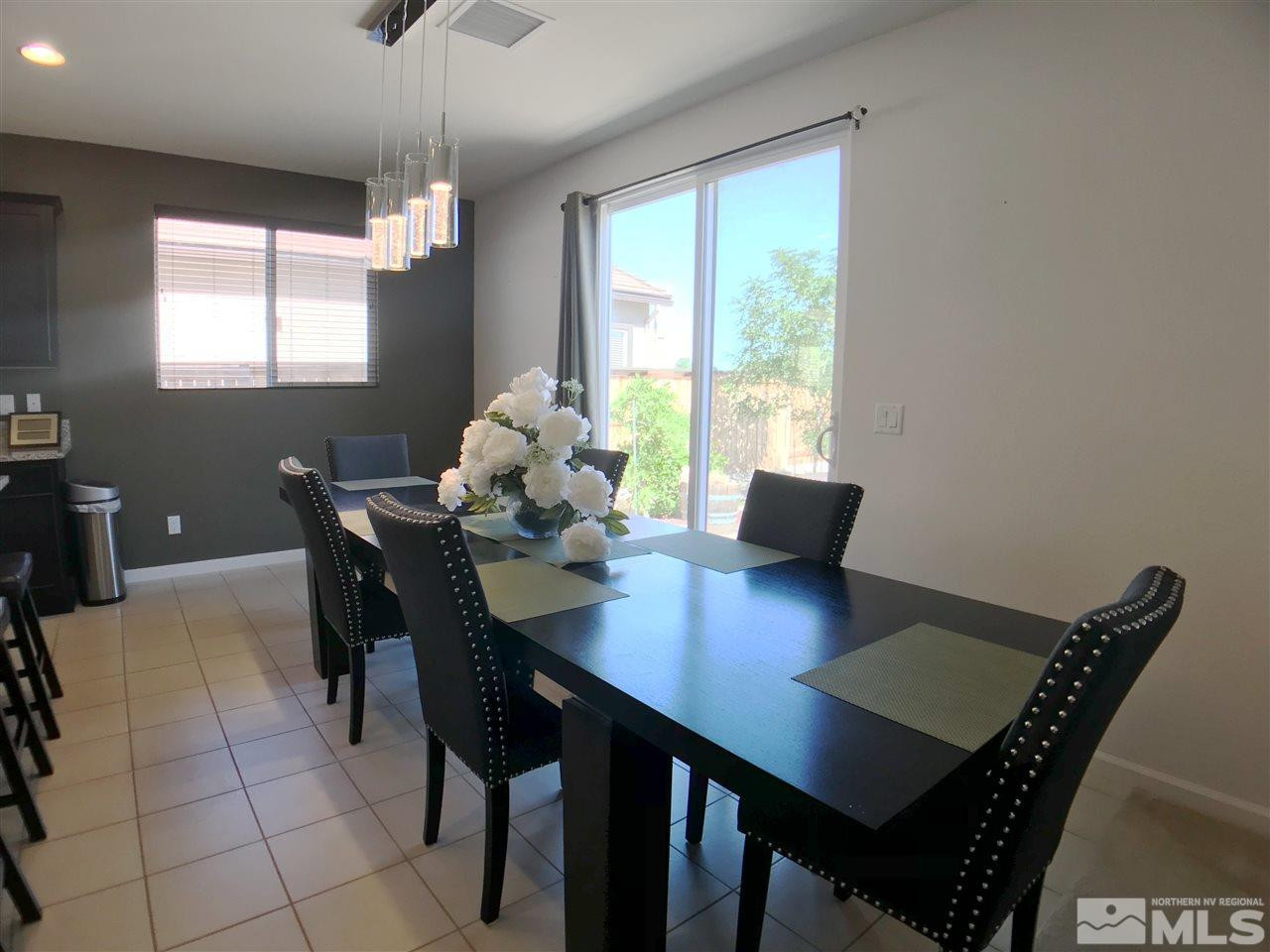 2935 Show Jumper Lane Reno, NV 89521 - Photo 4 of 19 a view of a dining room with furniture window and wooden floor