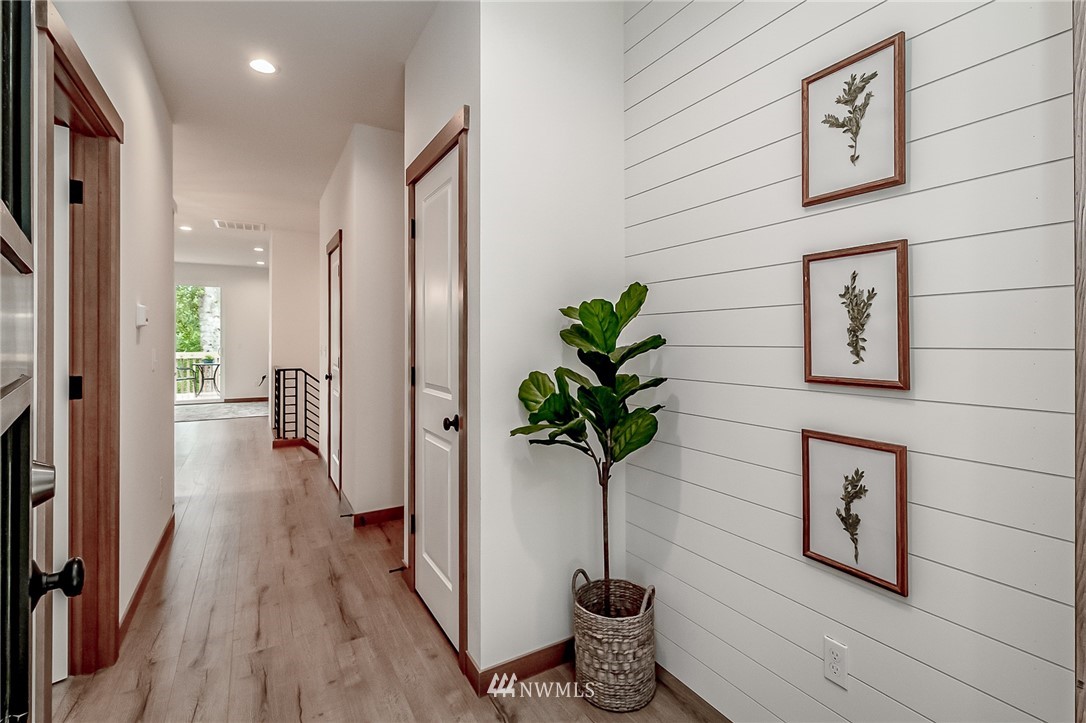 2624 Callow Road, Unit A Lake Stevens, WA 98258 - Photo 4 of 22 a view of a hallway with wooden floor and a potted plant