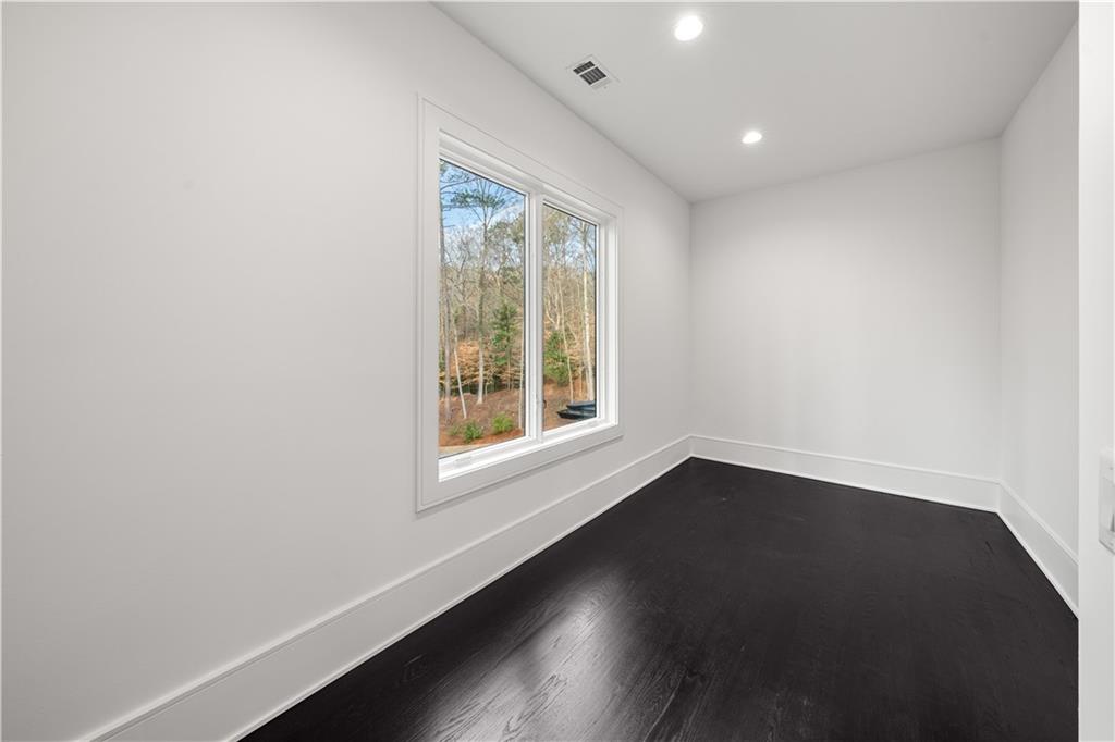 5211 Powers Ferry Road Northwest Sandy Springs, GA 30327 - Photo 87 of 106 an empty room with wooden floor and windows