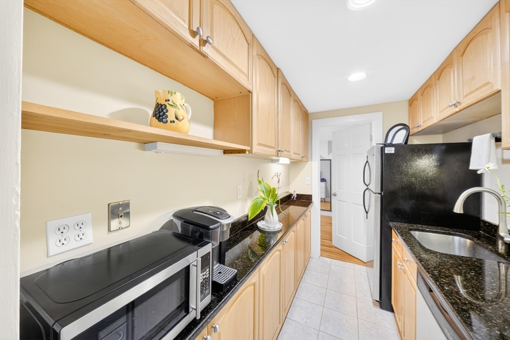 352 Tappan Street, Unit 1 Brookline, MA 02445 - Photo 17 of 42 a kitchen with stainless steel appliances a stove a refrigerator and cabinets