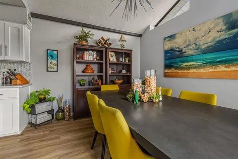a dining room with furniture and wooden floor