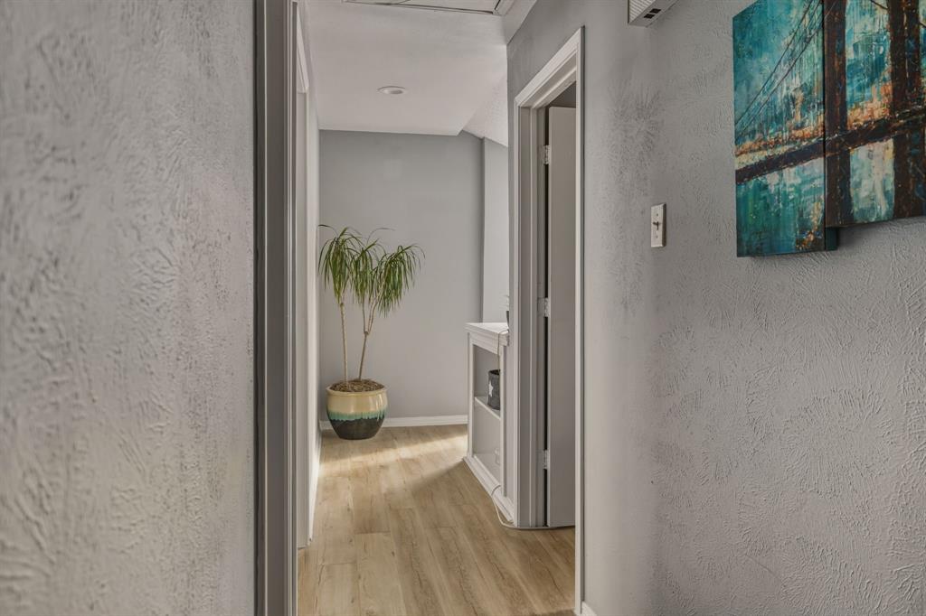 705 Via Miramonte Mesquite, TX 75150 - Photo 15 of 28 a view of a hallway with wooden floor and a livingroom
