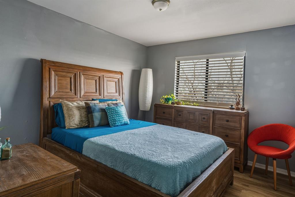 705 Via Miramonte Mesquite, TX 75150 - Photo 17 of 28 a bedroom with a bed and dresser with mirror