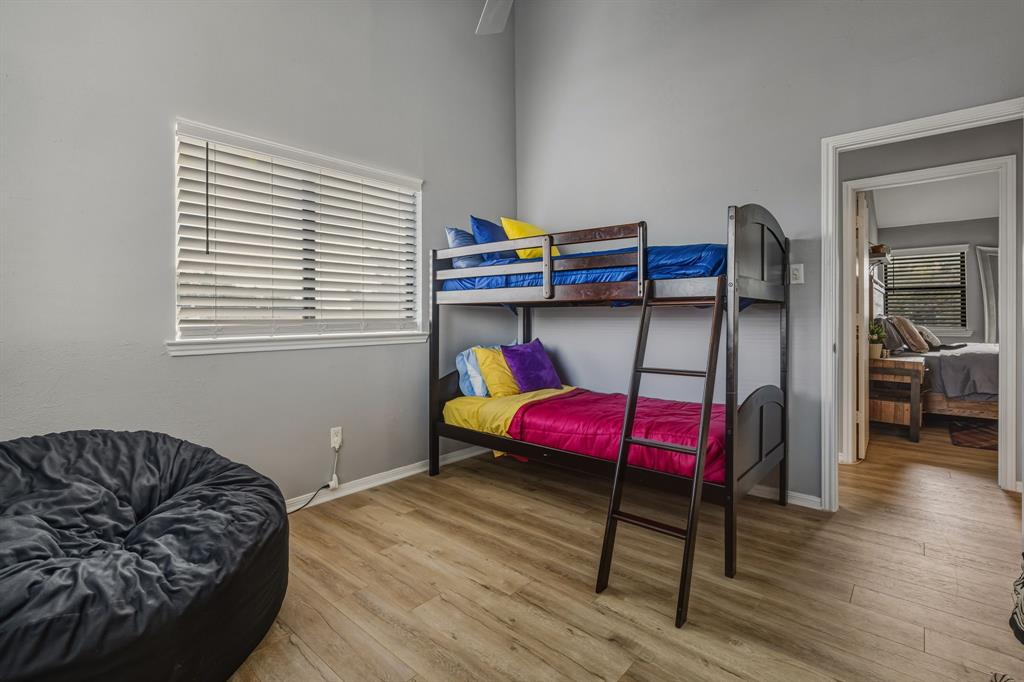 705 Via Miramonte Mesquite, TX 75150 - Photo 18 of 28 a bedroom with a bed and wooden floor