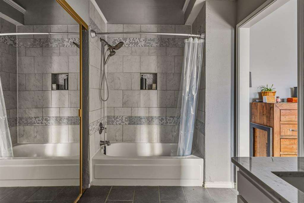 705 Via Miramonte Mesquite, TX 75150 - Photo 20 of 28 a bathroom with a shower and a tub