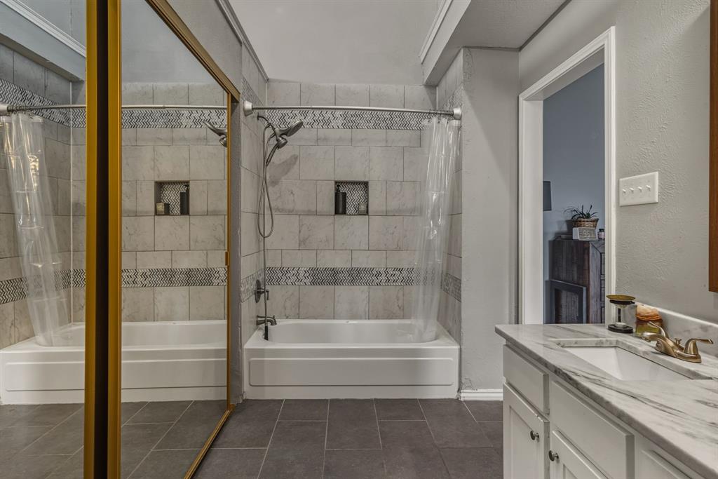 705 Via Miramonte Mesquite, TX 75150 - Photo 21 of 28 a bathroom with a granite countertop tub shower and sink