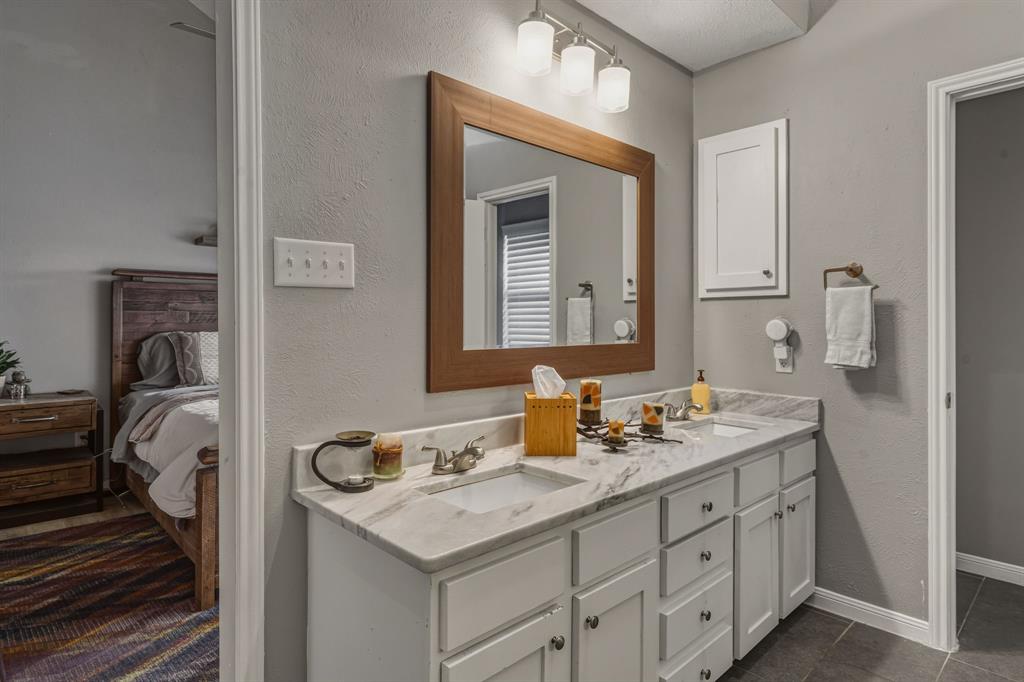 705 Via Miramonte Mesquite, TX 75150 - Photo 22 of 28 a bathroom with a sink and a mirror