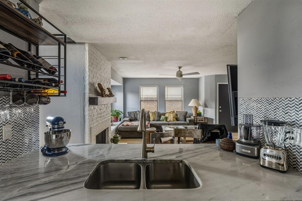 705 Via Miramonte Mesquite, TX 75150 - Photo 25 of 28 a kitchen with sink refrigerator and cabinets