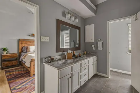 a bathroom with a double vanity sink and a mirror