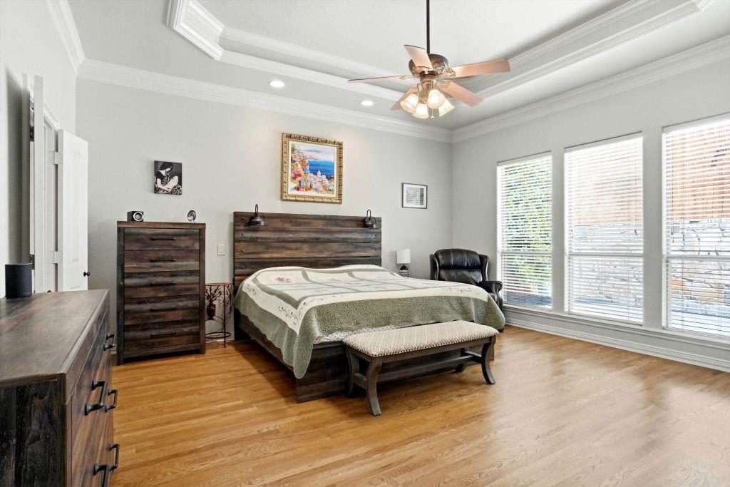 620 Highview Lane Hurst, TX 76054 - Photo 25 of 40 a bedroom with a bed and a chandelier