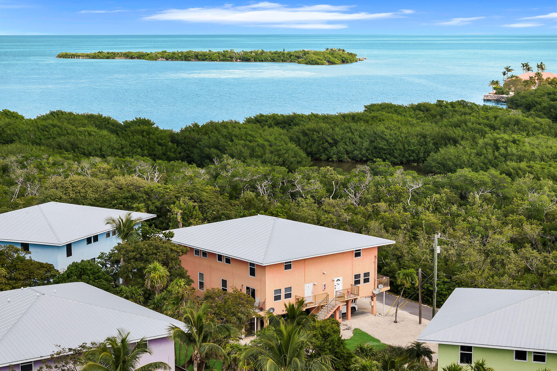 an aerial view of a house with outdoor space and lake view