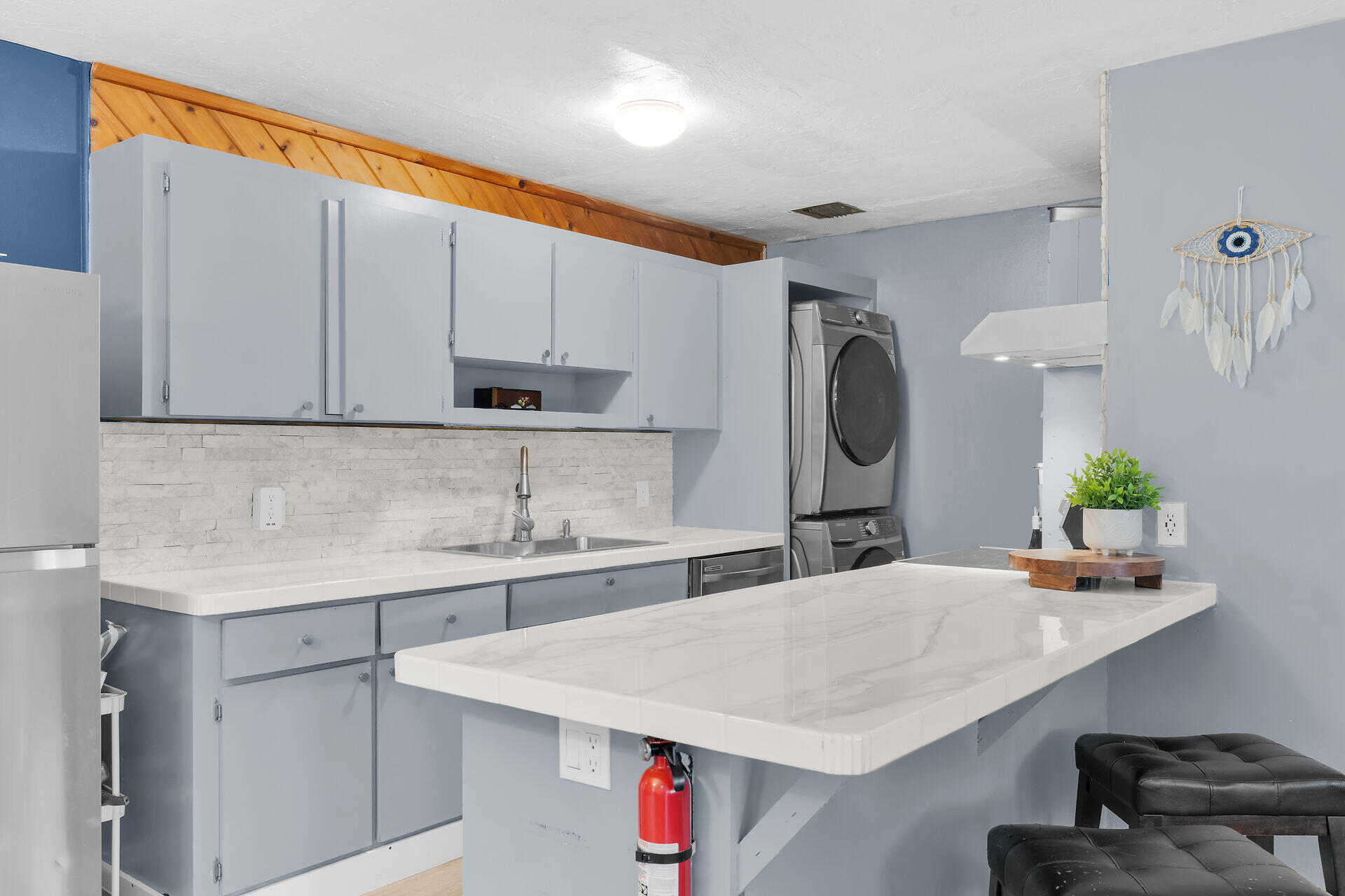 111 Stirrup Key Woods Road, Unit 2B1 Marathon, FL 33050 - Photo 13 of 36 a kitchen with a sink a microwave and cabinets