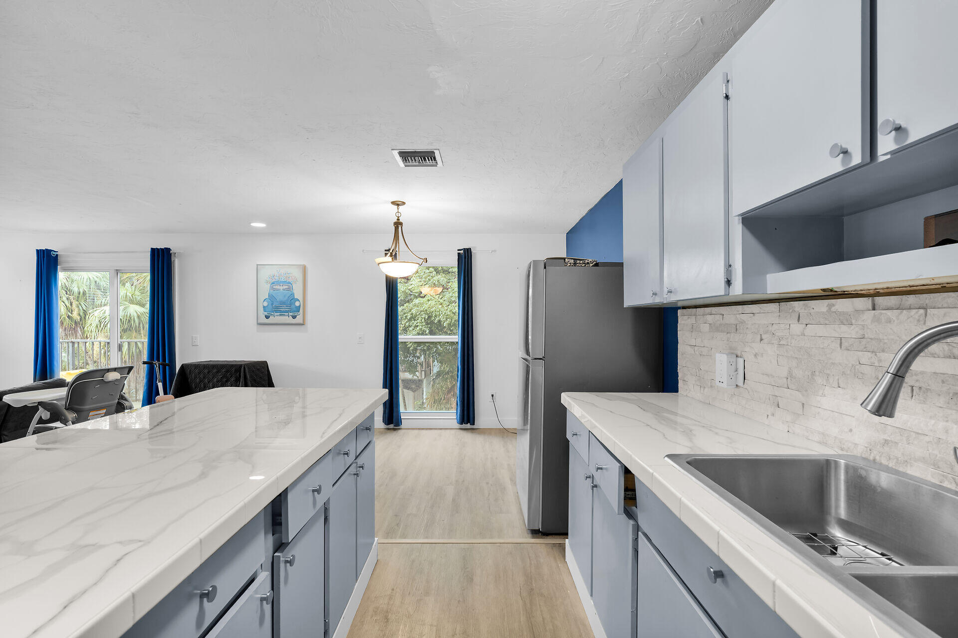 111 Stirrup Key Woods Road, Unit 2B1 Marathon, FL 33050 - Photo 16 of 36 a kitchen with stainless steel appliances kitchen island granite countertop a sink and a refrigerator