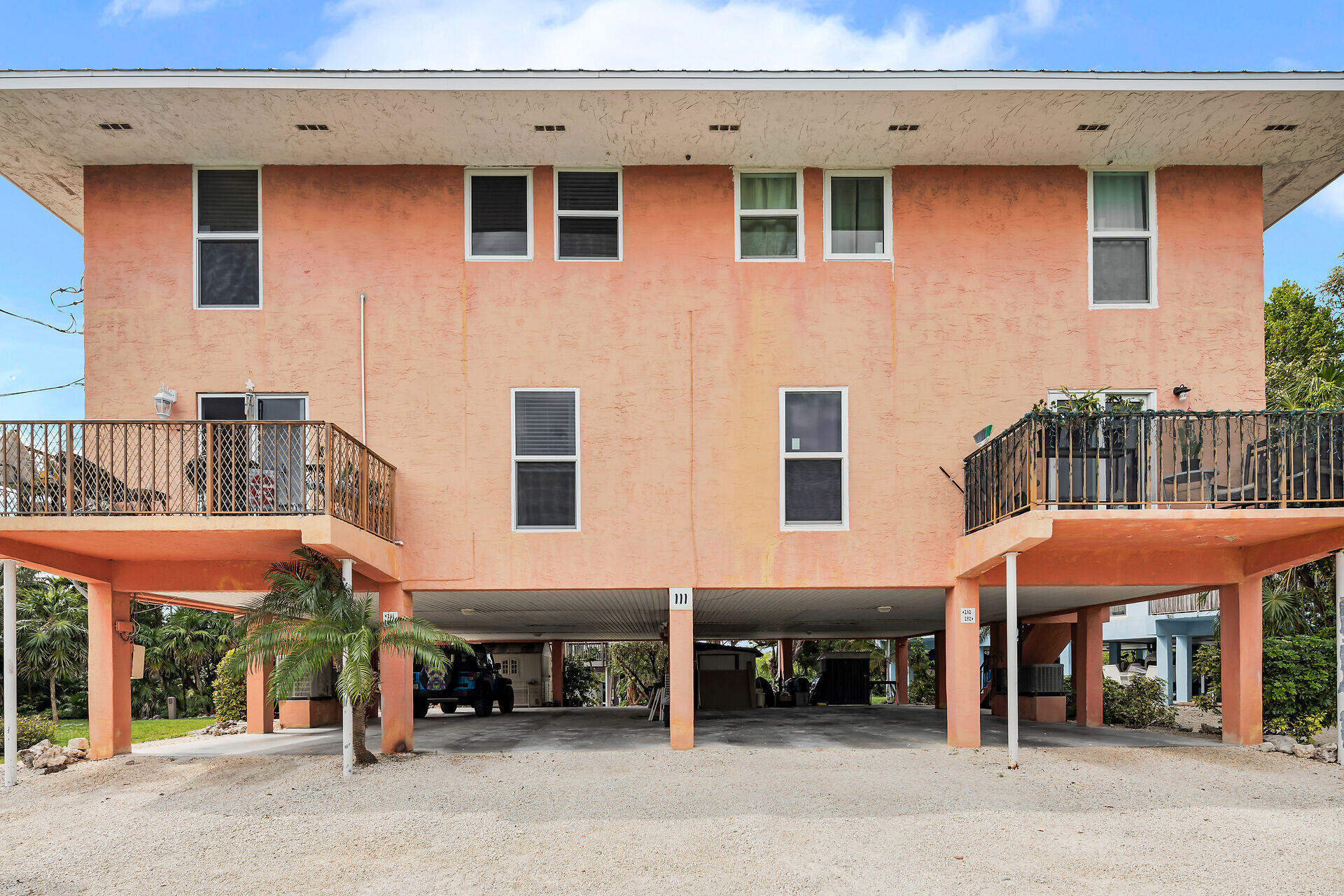 111 Stirrup Key Woods Road, Unit 2B1 Marathon, FL 33050 - Photo 5 of 36 a view of a cafe with a table and chairs under an umbrella