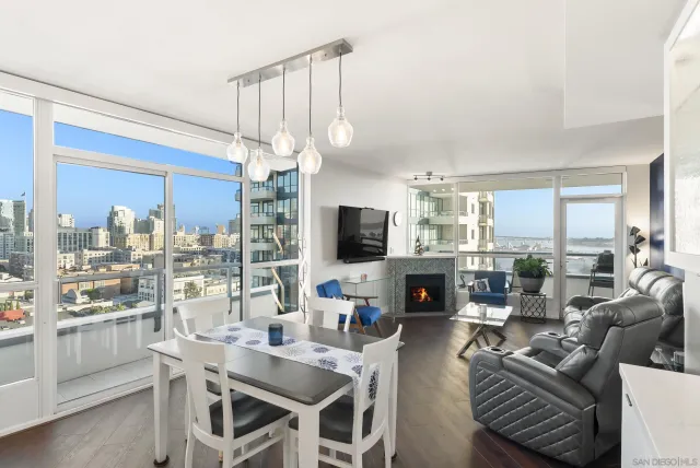 a living room with furniture a flat screen tv and a large window