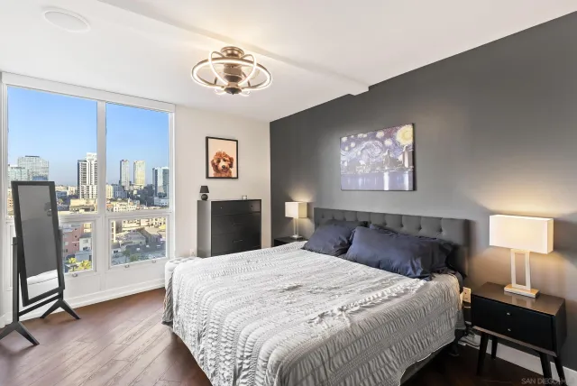 a bedroom with a large bed and a chandelier