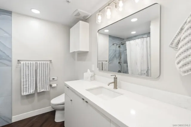 a bathroom with a sink toilet and shower