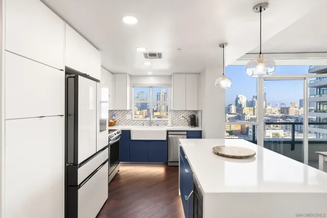 a kitchen with kitchen island a sink appliances and cabinets