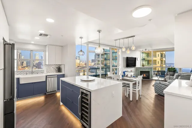 a kitchen with a sink stove and wooden floor