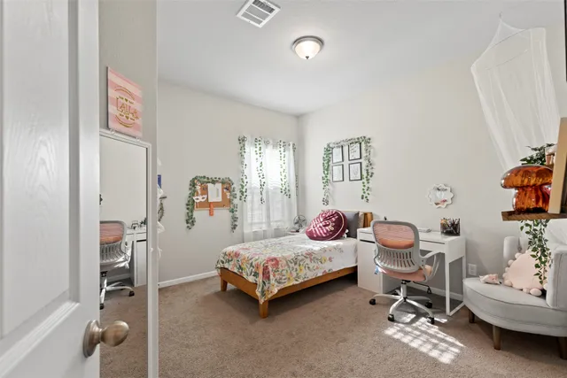 a bedroom with a bed and a couch