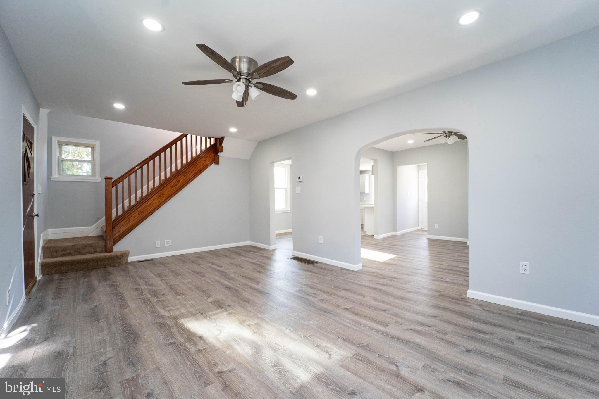 5312 Catalpha Road Baltimore, MD 21214 - Photo 12 of 41 a view of an empty room with wooden floor and a ceiling fan