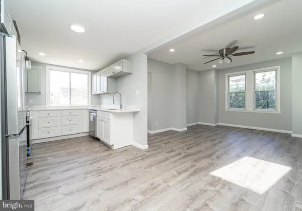 a view of a kitchen with a sink and windows