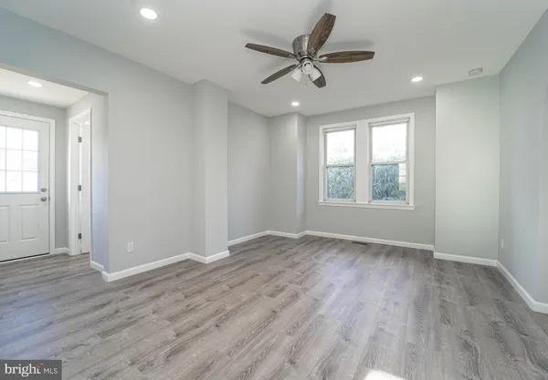 wooden floor in an empty room with a window