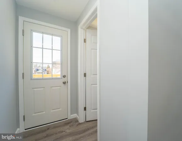 a view of an entryway with wooden floor