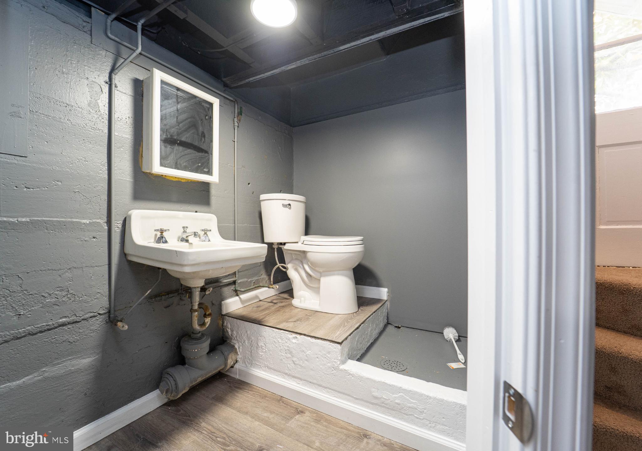 5312 Catalpha Road Baltimore, MD 21214 - Photo 28 of 41 a bathroom with a sink toilet and mirror